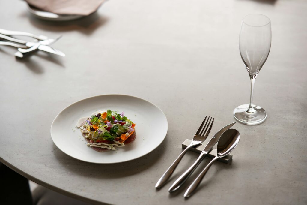 A stylish dining setup in a Tokyo restaurant featuring a gourmet salad dish and chic tableware.